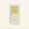 The Poppy Tile Florence Napkin by Good Juju Homeware showcases a vibrant poppy tile print with a floral design and abstract checkered pattern in pink, yellow, and green, ideal for adding a cheerful touch to your home.