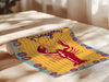 Colorful paper with a lobster design and 'Pizagata' text on a wooden surface.