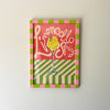Decorative sign with 'Limoncello Spritz' text and a glass illustration on a striped background.