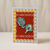 Chilli Greeting Card by Good Juju Homeware with a yellow checked border, red background, and two illustrated chillies. "CHILLI" appears at the top and bottom, printed on premium card stock.
