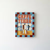 A square framed wall art print featuring a retro-style Italian coffee sign with the text 'CAFFETTIERA' and an illustration of a moka pot, hung on a plain white wall.