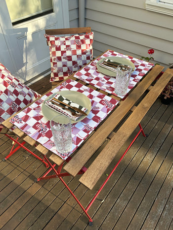 A Melbourne-based designer has created The Checkered Calla Lily Pillow Case from Good Juju Homeware, a red and white checkered tablecloth perfect for adding some festive flair to your dining space. This decorative piece is a versatile addition.