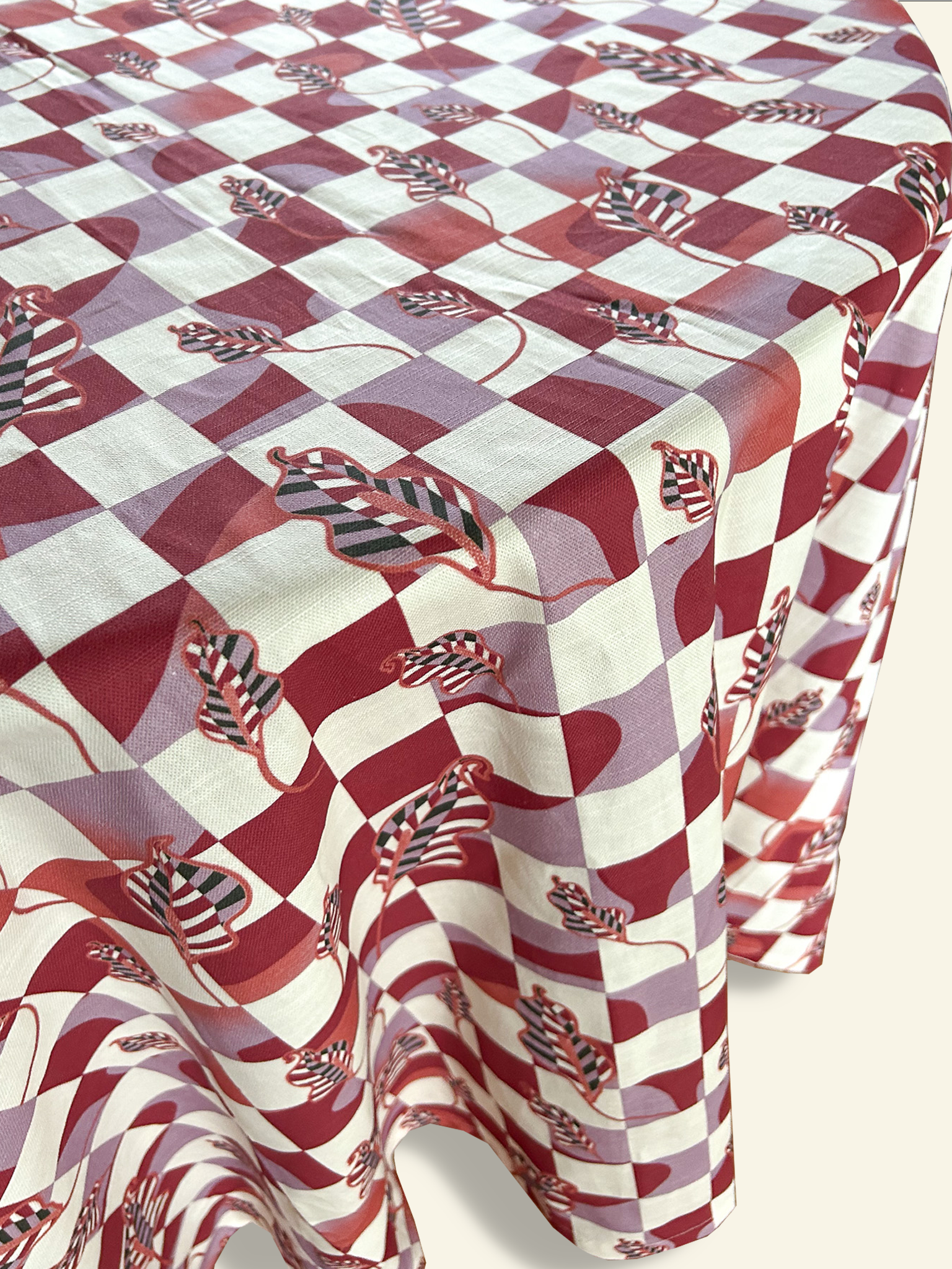 A red and white checkered tablecloth on a table. 	