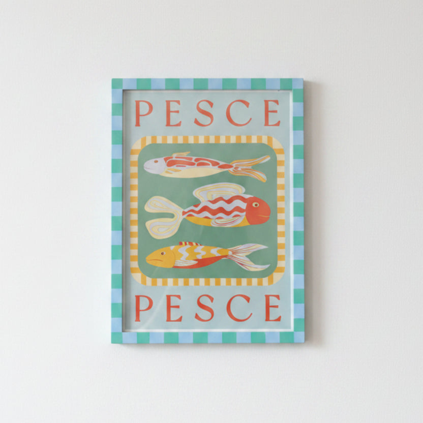A framed artwork from Good Juju Homeware with three colorful fish and "PESCE" text, set in an A3 Dark Turquoise and Light Green Painted Frame.