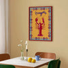 Dining room with a colorful lobster painting on the wall, table with lemon and cup, and chairs.