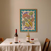 Dining table with wine bottles and a glass, framed artwork on the wall.