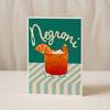 A Good Juju Homeware greeting card featuring an illustration of an Espresso Martini with ice and a coffee bean, set against a green striped background with "Espresso Martini" at the top—a perfect retro card for cocktail lovers.