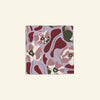 Good Juju Homeware's Poppies All Around Venice Napkin displays a vibrant abstract floral pattern in red, green, and white set against a purple background.