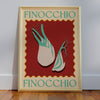 The Sunday Fenoccio Wall Art by Good Juju Homeware features illustrated fennel bulbs on a vibrant red background, elegantly framed with a decorative border. "FINOCCHIO" is artistically displayed at the top and bottom, adding Mediterranean flair.