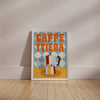 Framed poster with 'Gaffe Tierra' text and coffee pot design on a beige wall.