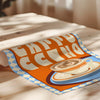 Roll of paper with a coffee-themed design on a wooden surface