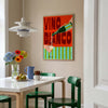Dining room with a table, chairs, and a colorful painting on the wall.