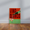 Colorful poster with 'Vino Blanco' text and wine bottle on a wooden floor against a white wall.
